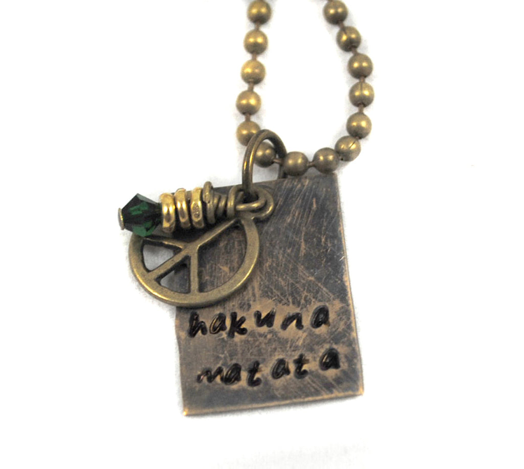 Hakuna Matata - Antiqued Brass Handstamped Rectangle Necklace with Green Crystal and Peace sign